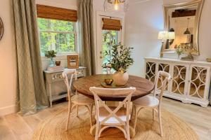 a dining room with a table and chairs and a mirror at Dragonfly Cabin in Scaly Mountain