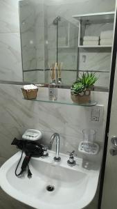 a bathroom with a white sink and a mirror at Apart Saavedra in Concordia