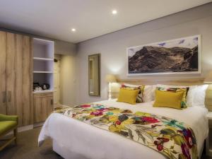 a bedroom with a large bed with yellow pillows at Mantis St Helena in Jamestown +66 photos