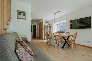 a living room with a couch and a table at Domki Tymianek & Melisa in Kościelisko +100 photos