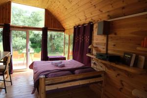 a bedroom with a bed in a log cabin at Riverside Apartment in Nikšić