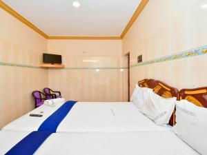 a bedroom with a large bed and a tv at SNN Residency in Rāmeswaram +7 photos