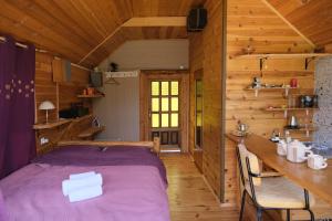 a bedroom with a bed and a table in a cabin at Riverside Apartment in Nikšić