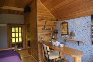 a wooden cabin with a wooden table and a bed at Riverside Apartment in Nikšić +4 photos