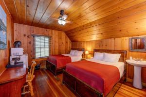 a bedroom with two beds in a wooden room at Union Creek Resort in Union Creek