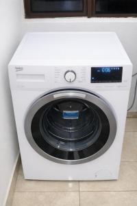 a white washer and dryer in a kitchen at Wilo Residence in Victoria Falls