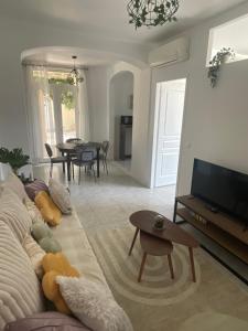a living room with a couch and a television at Appart dans bâtisse provençale in Sorgues