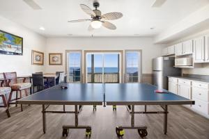 a dining room and kitchen with a ping pong table at 8046 - Sun Runner in Rodanthe