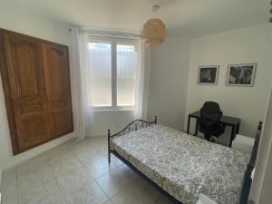 a bedroom with a bed and a window and a door at Appart dans bâtisse provençale in Sorgues