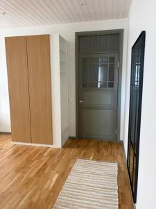 an empty room with a door and a rug at Aia Home in Kuressaare +1 photo