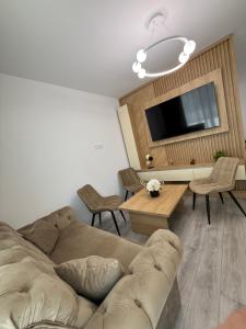a living room with a couch and a table at Urban Elegance in Cluj-Napoca