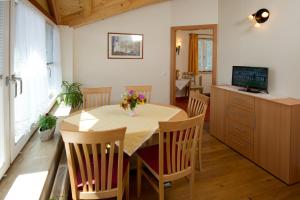 a dining room with a table with chairs and a television at Haus Martina in Radstadt