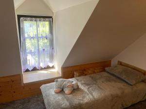 a stuffed animal sitting on a bed in a bedroom at Chalupa Obora in Cerhonice