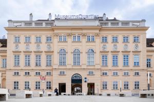 a building with clocks on the front of it at Premium Duplex 2BR for 6 with Balcony near City Museums Metro U3 U2 in Vienna