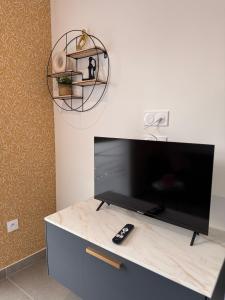 a flat screen tv sitting on top of a dresser at 101 - Centre de voiron in Voiron