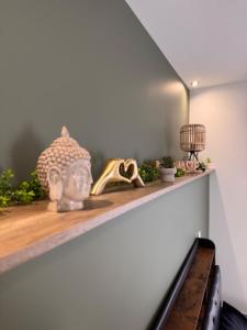 a shelf with a pair of shoes and a vase at 101 - Centre de voiron in Voiron