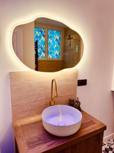 a bathroom with a sink with a mirror at Quartier Général des Gamers Arcade Terrasse in Saint-Omer +6 photos