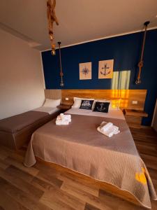 a bedroom with two beds and a blue wall at Tramonto di Calabria in Pizzo