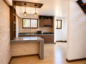 a kitchen with a sink and a counter at Qantu casa Boutique in Calca