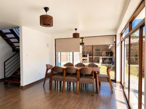 a dining room with a table and chairs at Qantu casa Boutique in Calca