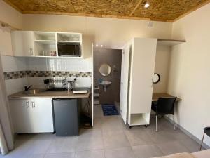 a small kitchen with a sink and a counter at Windy Dunes Self -Catering Accommodation, Luderitz in Lüderitz