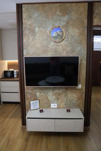 a large flat screen tv on a wall at Joni s Guest House in Krujë