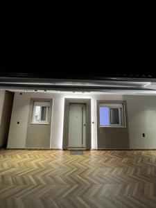 an empty room with two doors and a wooden floor at Thomas Luxury home in Plisioí +38 photos