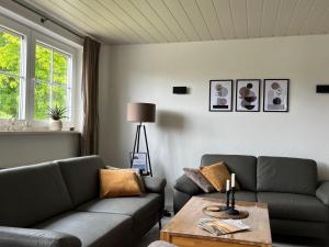 a living room with two couches and a coffee table at Große Auszeit in Gammendorf