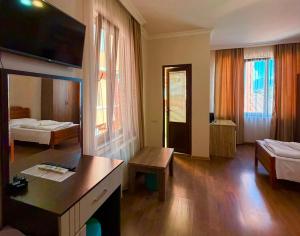 a hotel room with a bedroom with two beds at Marani Hotel in Batumi +89 photos