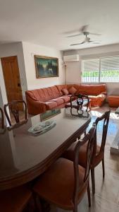 a living room with a couch and a table and chairs at Casa Rural Tío Cuchi in Bolbaite