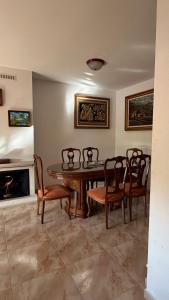 a dining room with a table and chairs and a fireplace at Casa Rural Tío Cuchi in Bolbaite