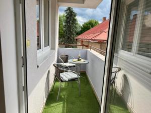 a small balcony with a table and chairs on it at Šturka Apartment in Martin