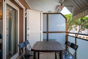 a table and chairs sitting on a balcony at AT121 Con piscina y cerca de la playa in Torredembarra +21 photos