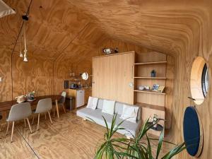 a living room with a couch and a table at Wikkelboats at Wijnhaven in Rotterdam