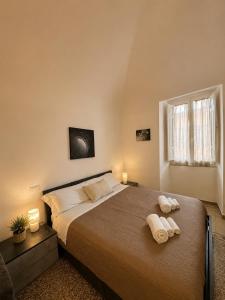 a bedroom with a large bed with two towels on it at Giulivi Assisi Apartments in Assisi
