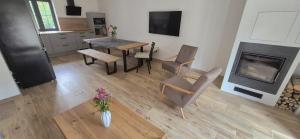 a living room with a table and chairs and a fireplace at House by the water in Lesík +20 photos