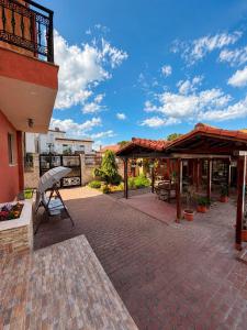 a patio with tables and chairs and a building at Vila Patricia in Eforie Sud +23 photos