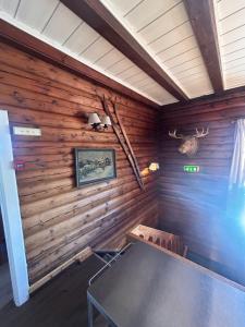 a room with wooden walls with a table in it at Knutehytta in Kongsberg