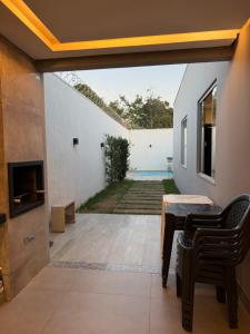 an internal view of a house with a patio with a table and chairs at Casa no Bairro Reserva Real in Montes Claros