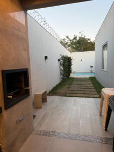 an internal courtyard of a house with a fireplace at Casa no Bairro Reserva Real in Montes Claros