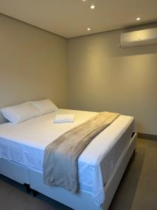 a bedroom with a large bed with white sheets at Casa no Bairro Reserva Real in Montes Claros +11 photos
