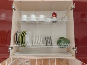 a cupboard with plates and dishes in it at Apartment Ekaterina in Chornomorsk +15 photos