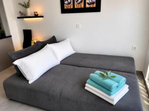 a bed with towels on top of it in a room at Whisper wave in Haraki