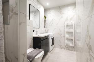 a bathroom with a toilet sink and a washing machine at Newly built detached house with parking 2 in Larisa +32 photos