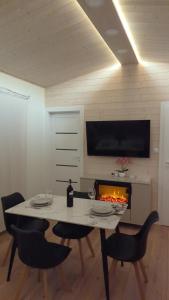 a dining room with a table and a fireplace at Dom nad wąwozem in Sandomierz