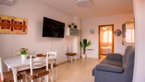 a living room with a table and a dining room at Apartalux Cielo Dorado in San Juan de los Terreros