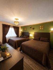 a hotel room with two beds and a table at Frontier Lodge in Lander