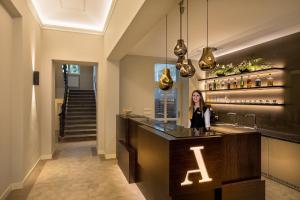 a woman standing at a bar in a building at Avenue Legerova 19 in Prague