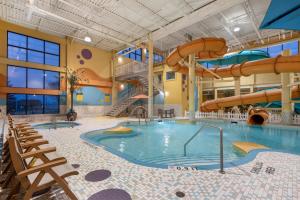 a large indoor swimming pool with a water slide at Best Western PLUS Port O'Call Hotel in Calgary