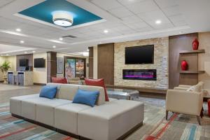 a living room with a couch and a tv at Best Western PLUS Port O'Call Hotel in Calgary